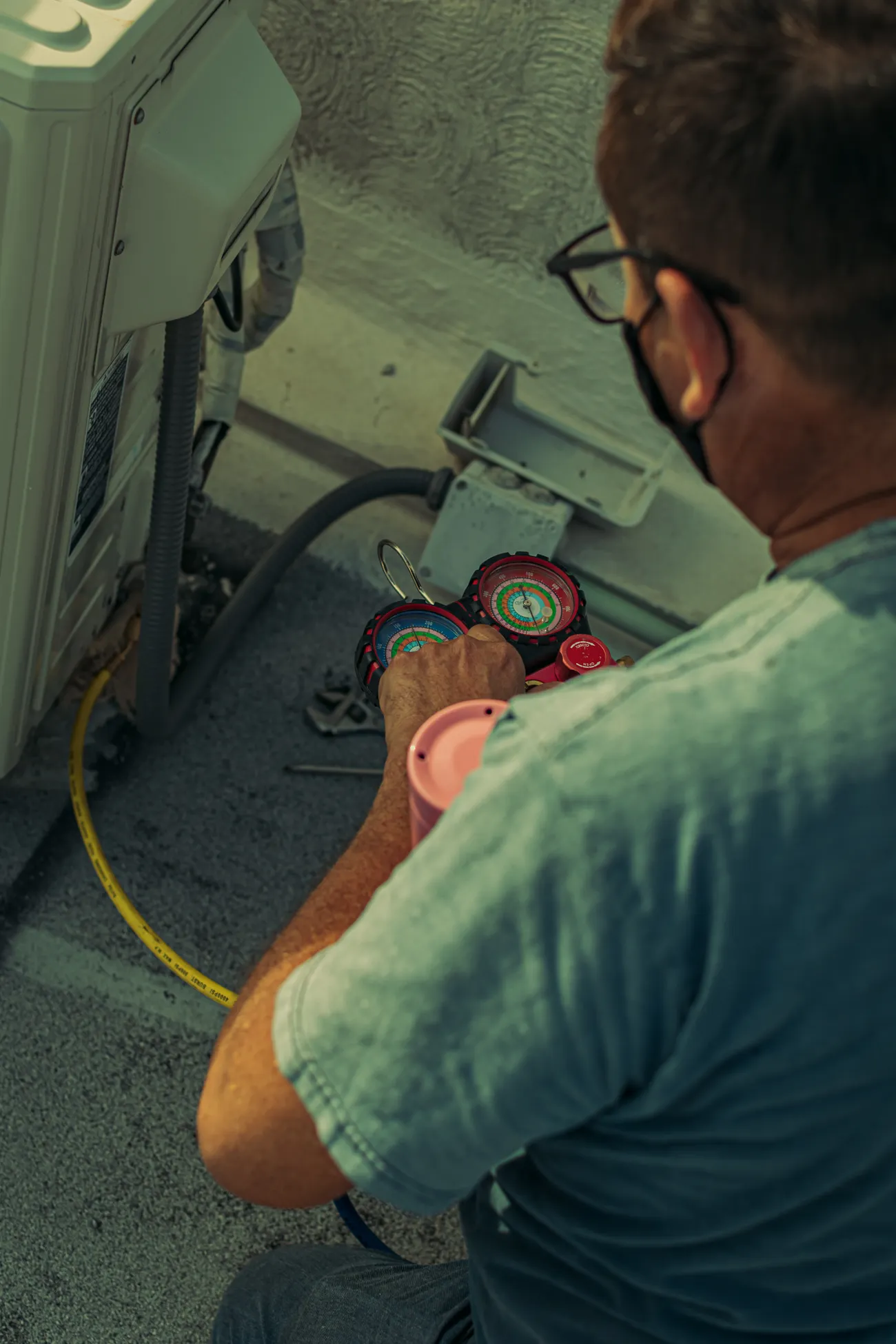 Technician servicing an outdoor air-conditioning system